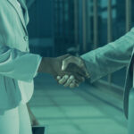 Two business professionals shaking hands, symbolizing trust and verified partnerships through Know Your Business (KYB) checks.