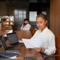 A lady reviewing documents in an office setting.