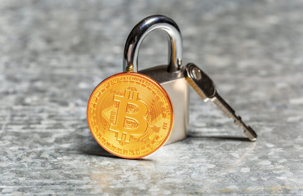 Padlock and key with Bitcoin representing KYC in crypto