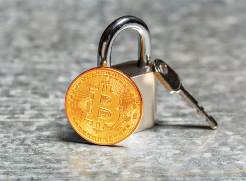 Padlock and key with Bitcoin representing KYC in crypto