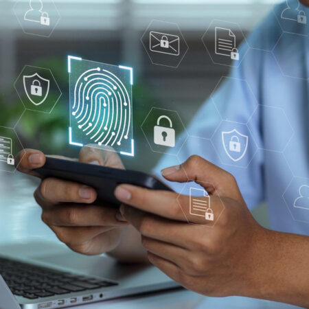 Hands holding a smartphone with digital lock and verification icons representing an age verification system